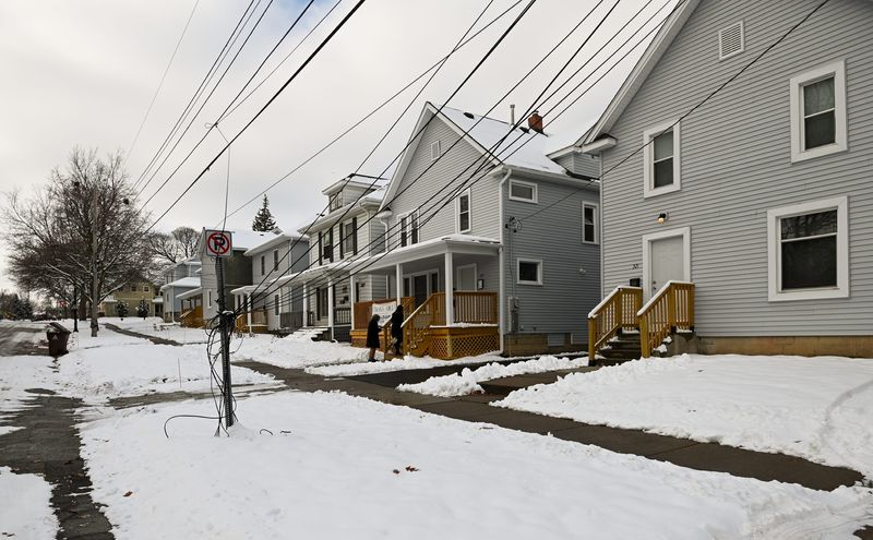 A row of homes on East St. Joseph Street in Lansing, seen Tuesday, Dec. 2, 2025, that are part of the new Cherry Hill Apartments. Six homes have been renovated by PK Companies in Lansing's historic Cherry Hill neighborhood and will be split into 20 mixed unit apartments, including studios and one- and two-bedroom units.