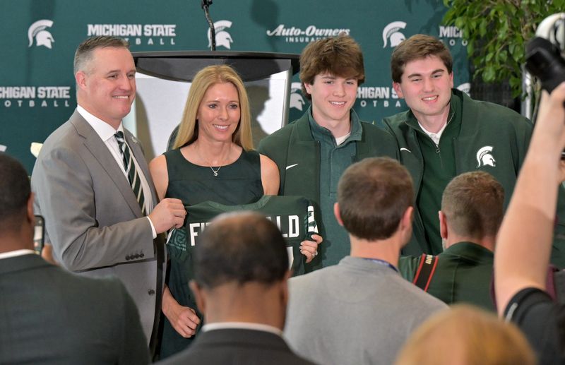 From left, Pat Fitzgerald is photographed with his wife, Stacy, and two of their three sons, Brendan and Ryan, after the press conference at Michigan State University in East Lansing, Mich. on Dec. 2, 2025.