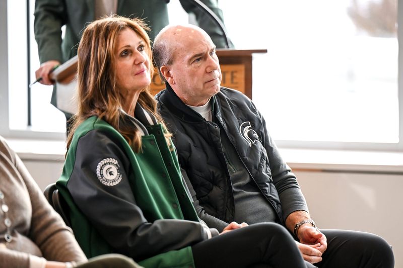 Dawn and Greg Williams listen to Michigan State's new football coach Pat Fitzgerald speak during the coach's introductory press conference on Tuesday, Dec. 2, 2025, at the Tom Izzo Football Building in East Lansing.