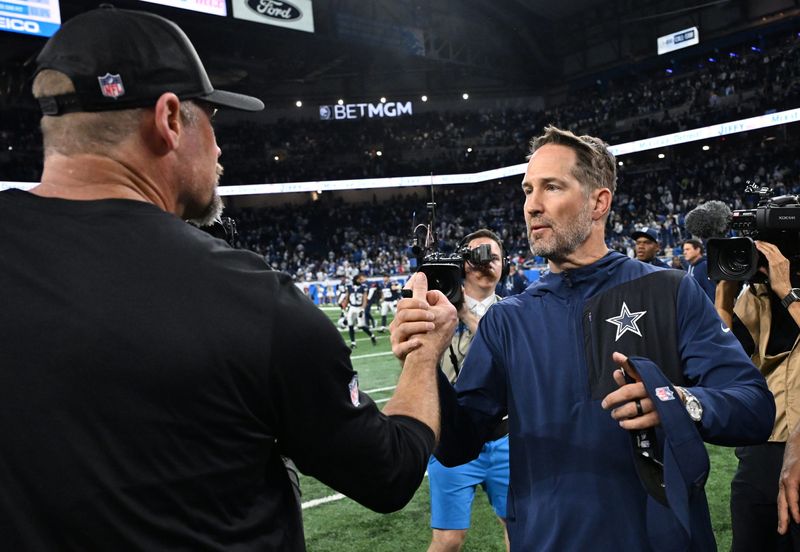 Dec 4, 2025; Detroit, Michigan, USA; Detroit Lions head coach Dan Campbell shakes hands with Dallas Cowboys head coach Brian Schottenheimer after a game at Ford Field. Mandatory Credit: Lon Horwedel-Imagn Images