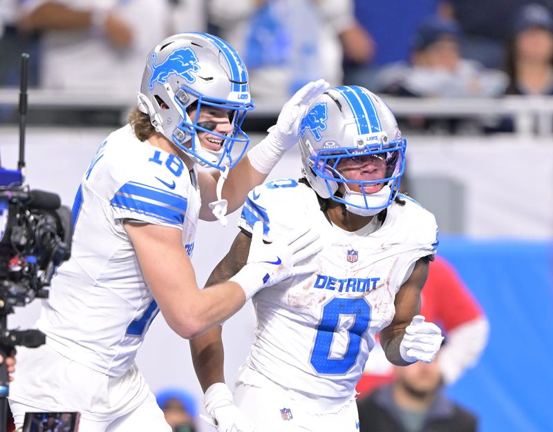 Lions wide receiver Isaac Teslaa (18) reacts with running back Jahmyr Gibbs (0) after Gibbs’ touchdown in the fourth quarter. Detroit Lions take on the Dallas Cowboys at Ford Field in Detroit on Dec. 4, 2025.