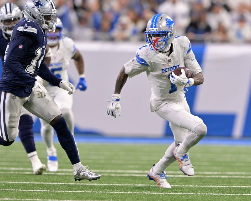 Lions wide receiver Jameson Williams (1) runs the ball away from Cowboys safety Markquese Bell (14) after a catch in the fourth quarter. Detroit Lions take on the Dallas Cowboys at Ford Field in Detroit on Dec. 4, 2025.