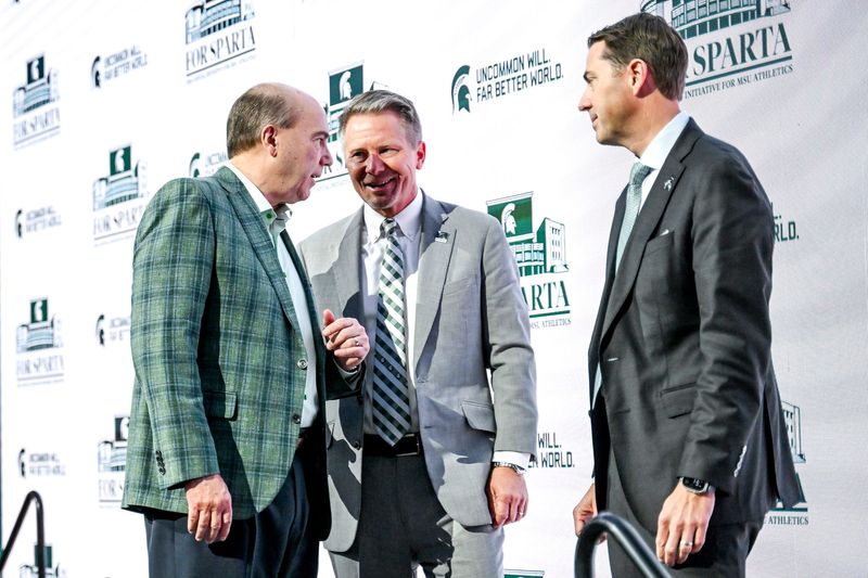Greg Williams, left, talks with MSU President KevinÊGuskiewicz, center, and MSU Athletic Director J Batt after an event announcing Williams' $401 million donation to the university on Friday, Dec. 5, 2025, at the Breslin Center in East Lansing.