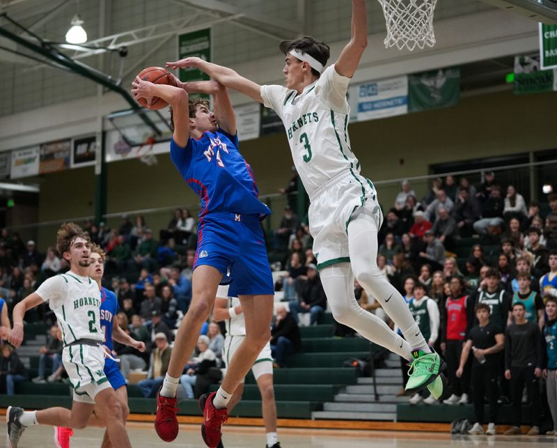 Gavin Greathouse of Mason shoots from the paint against Jameson Conti of Williamston, Friday, Dec. 5, 2025, during the season opener at Williamston. Mason won 63-57 in overtime.