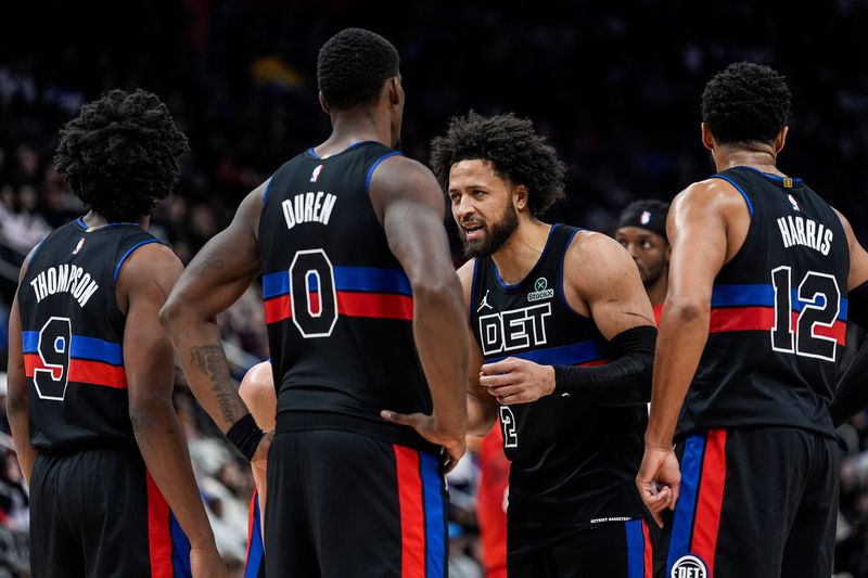Detroit Pistons guard Cade Cunningham (2) talks with forward Ausar Thompson (9), center Jalen Duren (0) and forward Tobias Harris (12) before a play against the Portland Trail Blazers during the second half at Little Caesars Arena in Detroit on Friday, Dec. 5, 2025.