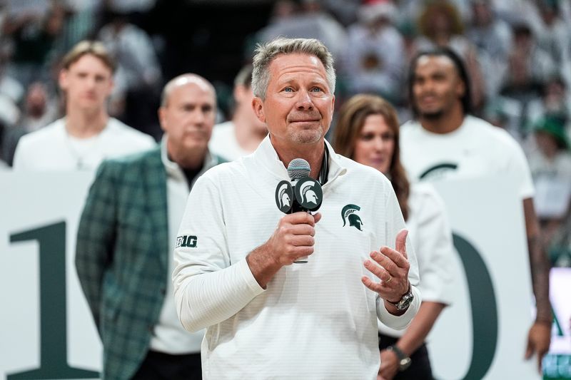 Michigan State president Kevin M. Guskiewicz, center, speaks, as the university honor Greg and Dawn Williams’ 401 Million Dollars donation to the university during halftime between the Michigan State and the Duke at Breslin Center in East Lansing on Saturday, Dec. 6, 2025.