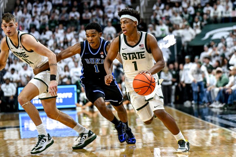 Michigan State's Jeremy Fears Jr., right, moves the ball as Duke's Caleb Foster defends during the second half on Saturday, Dec. 6, 2025, at the Breslin Center in East Lansing.