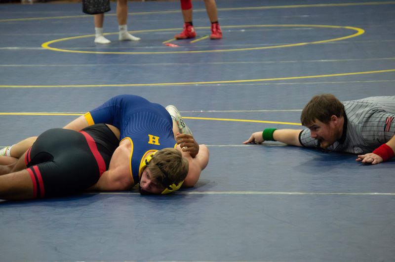 A Hillsdale grappler looks to pin a Reading wrestler in an opening season duel.