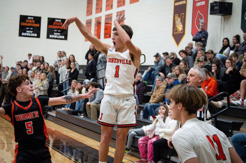 Caleb Blonde (1) hits a 3-pointer for Jonesville in their home opener against Homer.