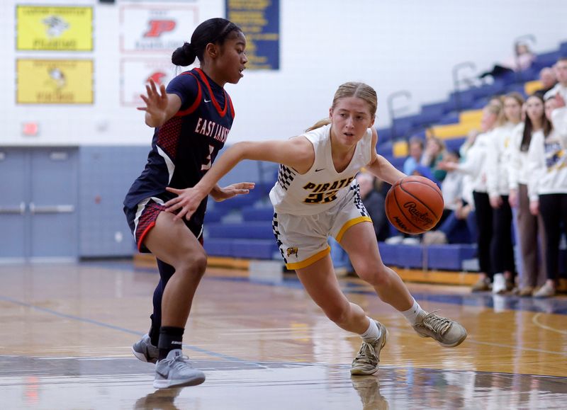 Pewamo-Westphalia's Elly Bengel, right, drives against East Lansing's Olivia Adarkwa, Tuesday, Dec. 9, 2025, at Pewamo-Westphalia High School.