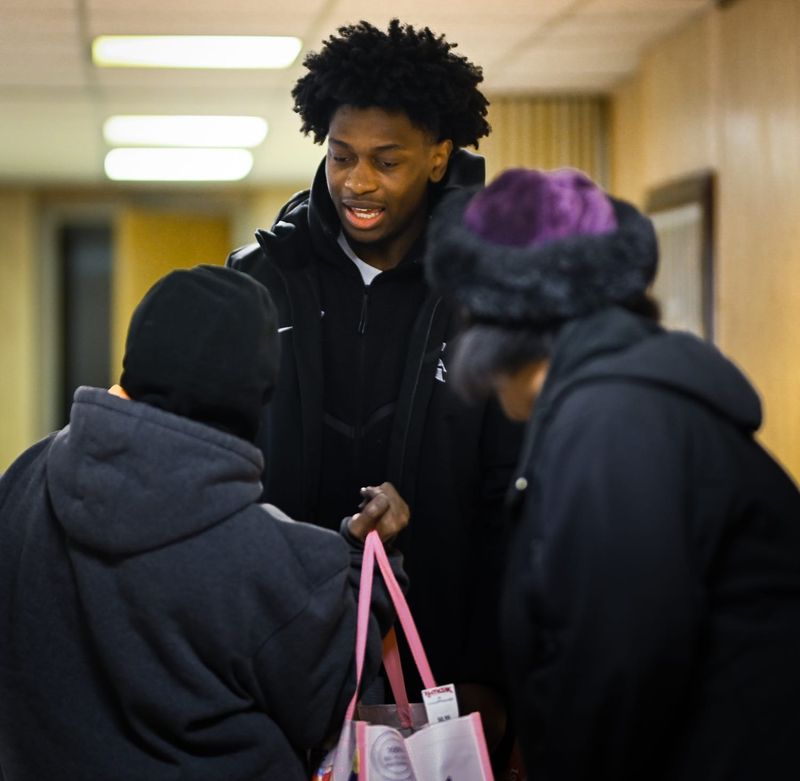 "I've been blessed, and it feels good to give back," Michigan State University senior guard Trey Fort said, pictured Thursday, Dec. 11, 2025, at the Eastside Community Action Center in the basement of Fellowship Baptist Church, where he helped disseminate large bags of groceries he paid for from his NIL (name, image, likeness) earnings. "It means a lot to those being helped, and I encourage others to do the same."