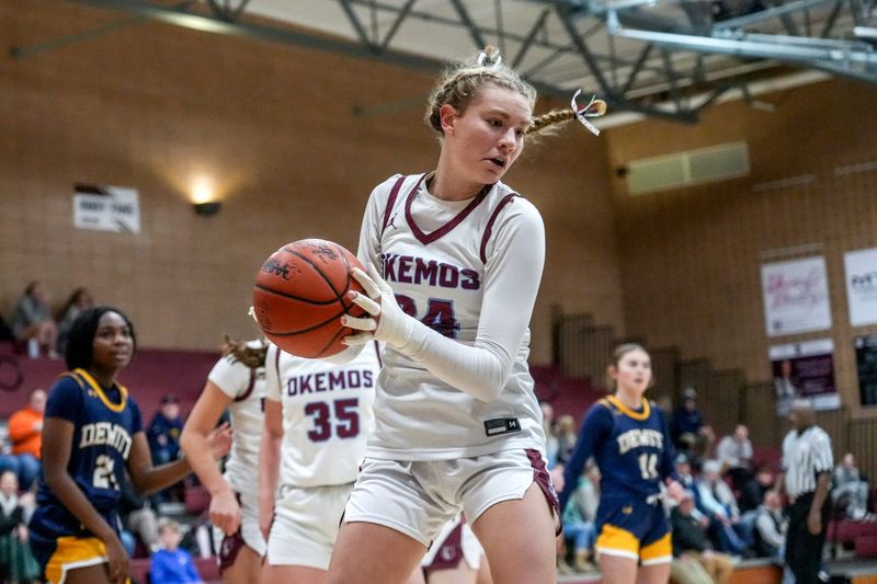 Okemos' Elizabeth Schafer grabs a rebound against DeWitt during the first quarter on Friday, Dec. 12, 2025, at Okemos High School.
