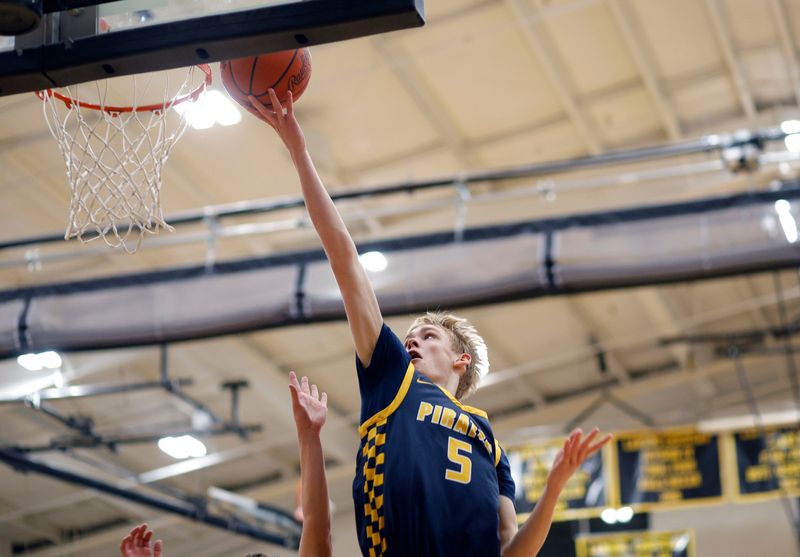 Pewamo-Westphalia's Logan Farmer gets a layup against Lansing Christian, Friday, Dec. 12, 2025, at Lansing Christian.