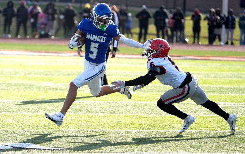 Detroit Catholic Central's Samson Gash scrambles out of the pocket stopping the defense of East Kentwood (5) Donavan Jones during the second half of the MHSAA Division 1 football semifinals between the two teals at Jackson High School in Jackson on Saturday, Nov. 22, 2025.
Catholic Central won the game 46-6 and will face Detroit Cass Tech in the Finals on Sunday, Nov. 30 at Ford Field for the Division 1 championship.