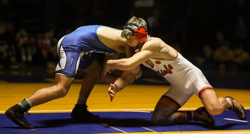 Dundee's Blake Cosby (left) attacks Josh Hubbard of New Boston Huron in the 165-pound finals of the 54th annual Monroe County Sheriff's Wrestling Invitational on Saturday, Dec. 13, 2025.