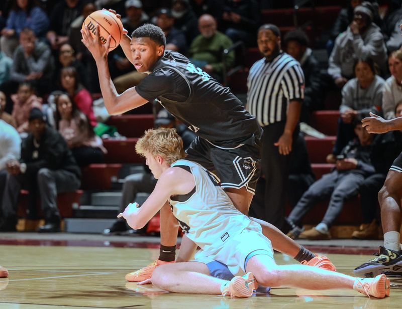 West Ottawa's Darien Stewart corrals a loose ball against Grand Rapids Christian on Saturday, Dec. 13, at Calvin University.