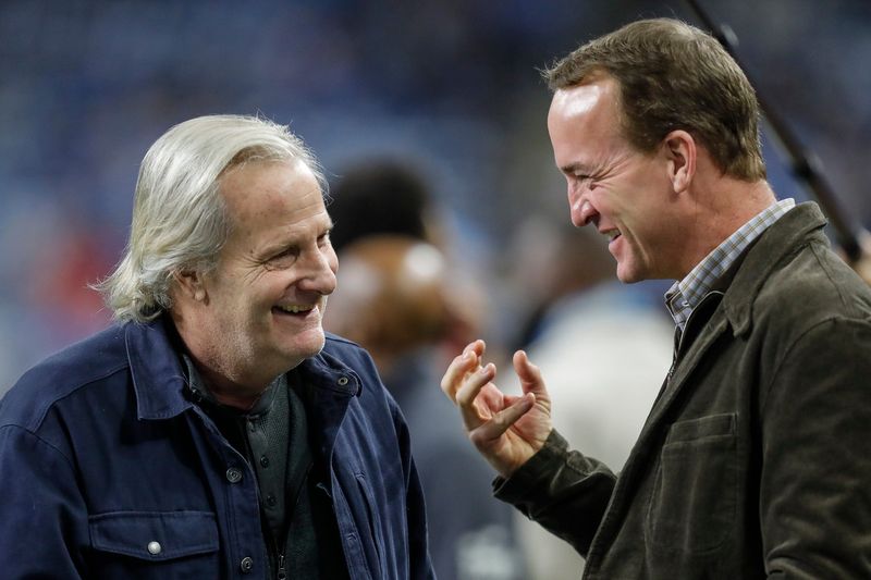 Jeff Daniels talks to Peyton Manning at warm up before the NFC divisional round at Ford Field in Detroit on Sunday, Jan, 21, 2024.