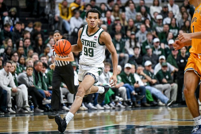 Michigan State's Divine Ugochukwu moves the ball against Toledo during the first half on Tuesday, Dec. 16, 2025, at the Breslin Center in East Lansing.