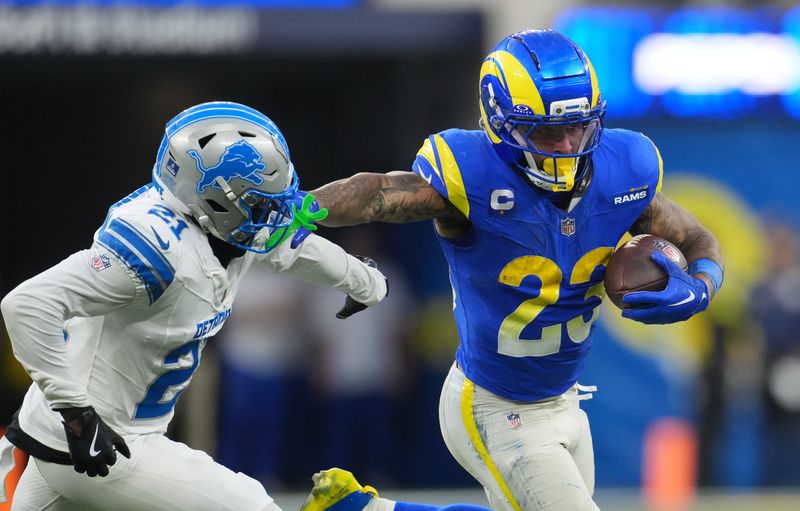 Dec 14, 2025; Inglewood, California, USA; Los Angeles Rams running back Kyren Williams (23) runs the ball against Detroit Lions cornerback Amik Robertson (21) during the fourth quarter at SoFi Stadium. Mandatory Credit: Kirby Lee-Imagn Images