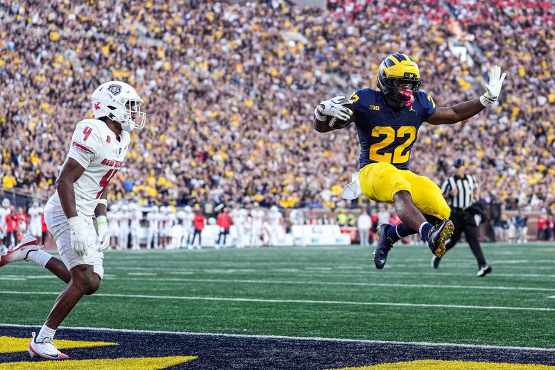 Michigan running back Justice Haynes (22) leaps into the end zone for a touchdown against New Mexico during the first half at Michigan Stadium in Ann Arbor on Saturday, August 30, 2025.