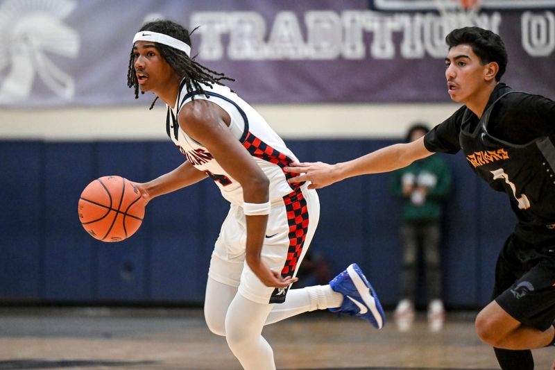 East Lansing's Tyree Anthony, left, moves the ball as Waverly's CJ Gomez defends during the second quarter on Thursday, Dec. 18, 2025, at East Lansing High School.