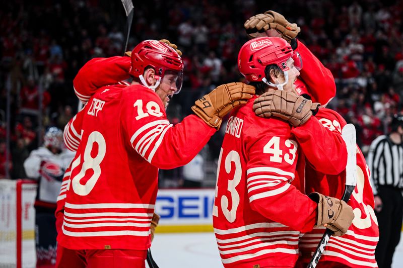 Detroit Red Wings left wing John Leonard (43) celebrates with center Andrew Copp (18) and right wing Alex Debrincat (93) during the second period against the Washington Capitals at Little Caesars Arena in Detroit on Sunday, Dec. 21, 2025.