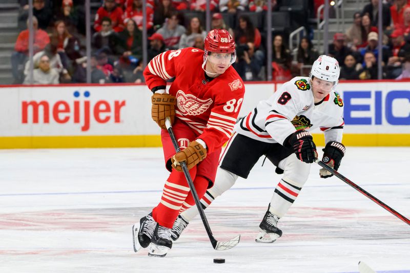 Detroit right wing Patrick Kane keeps the puck away from Chicago center Ryan Donato during the third period of a game between the Detroit Red Wings and the Chicago Blackhawks at Little Caesars Arena, in Detroit, November 9, 2025.
