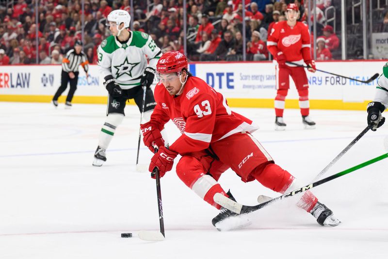 Detroit left wing John Leonard scoops up a loose puck during the first period of a game between the Detroit Red Wings and the Dallas Stars at Little Caesars Arena, in Detroit, December 23, 2025.