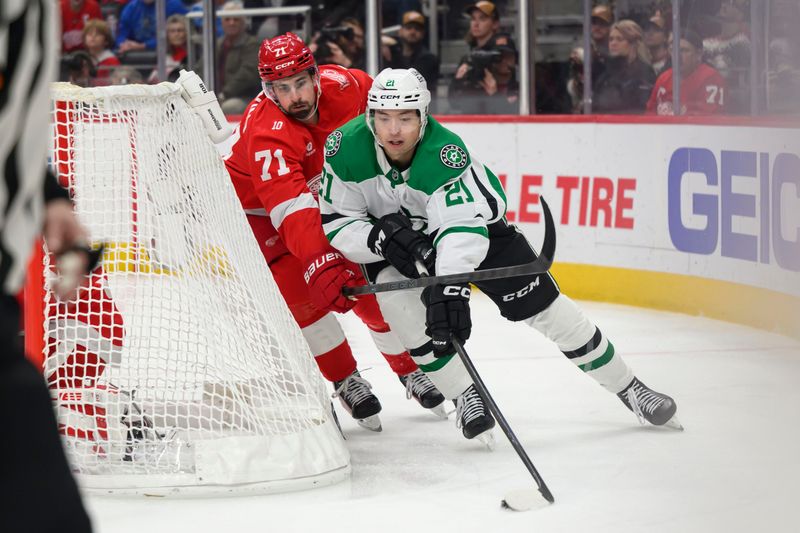 Detroit center Dylan Larkin tries to steal the puck away from Dallas left wing Jason Robertson during the second period of a game between the Detroit Red Wings and the Dallas Stars at Little Caesars Arena, in Detroit, December 23, 2025.