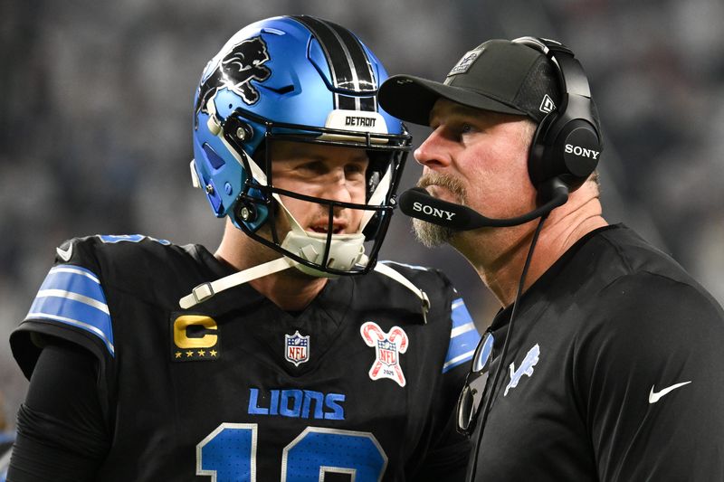 Dec 25, 2025; Minneapolis, Minnesota, USA; Detroit Lions quarterback Jared Goff (16) speaks with head coach Dan Campbell in the second quarter against the Minnesota Vikings at U.S. Bank Stadium. Mandatory Credit: Jeffrey Becker-Imagn Images