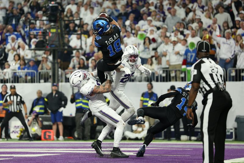 Detroit Lions wide receiver Isaac Teslaa (18) makes a catch for a touchdown defended by Minnesota Vikings linebacker Blake Cashman (51) and safety Harrison Smith (22) in the second quarter at U.S. Bank Stadium in Minneapolis on Thursday, Dec. 25, 2025.