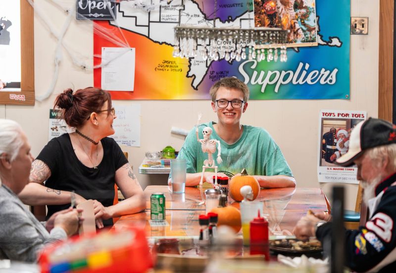 Angela Olin, left, of Ishpeming, laughs with her son Dylan Larson, 21, of Ishpeming, as they sit with his grandparents Neal and Cathy Larson, of Negaunee, on Wednesday, Oct. 29, 2025.