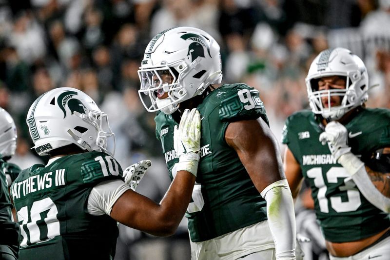 Michigan State's Jalen Thompson, right, celebrates his tackle for a safety against Western Michigan during the third quarter on Friday, Aug. 29, 2025, in East Lansing.