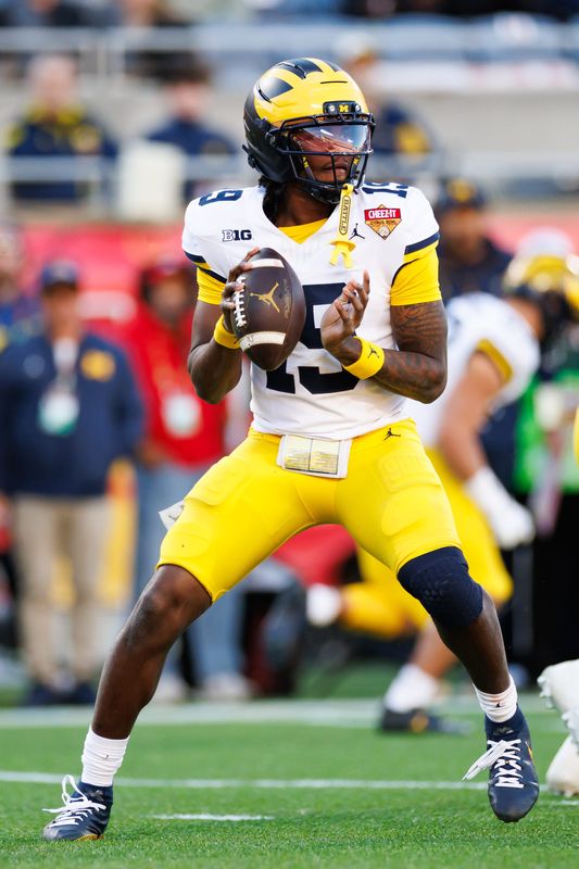 Michigan Wolverines quarterback Bryce Underwood (19) looks to throw against the Texas Longhorns during the first half at Camping World Stadium in Orlando, Florida, on Wednesday, Dec. 31, 2025.