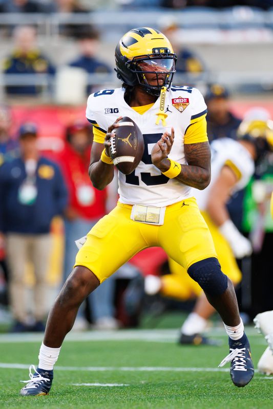 Michigan Wolverines quarterback Bryce Underwood (19) looks to throw against the Texas Longhorns during the first half at Camping World Stadium in Orlando, Florida, on Wednesday, Dec. 31, 2025.