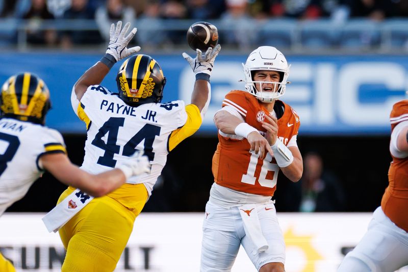 Michigan Wolverines defensive lineman Damon Payne (44) tips a pass from Texas Longhorns quarterback Arch Manning (16) during the first half at Camping World Stadium in Orlando, Florida, on Wednesday, Dec. 31, 2025.