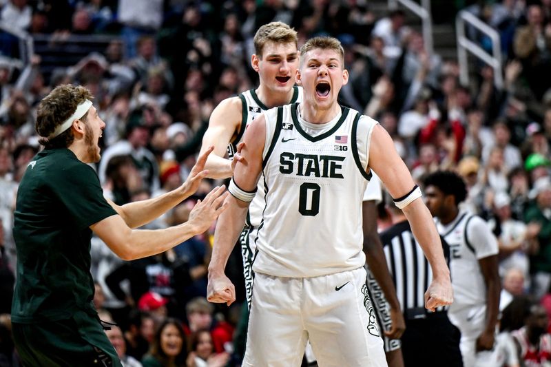 Michigan State's Jaxon Kohler, right, celebrates with teammates Carson Cooper, center, and Gehrig Normand, left, after a MSU score and Nebraska timeout during the second half on Saturday, Dec. 7, 2024, at the Breslin Center in East Lansing.