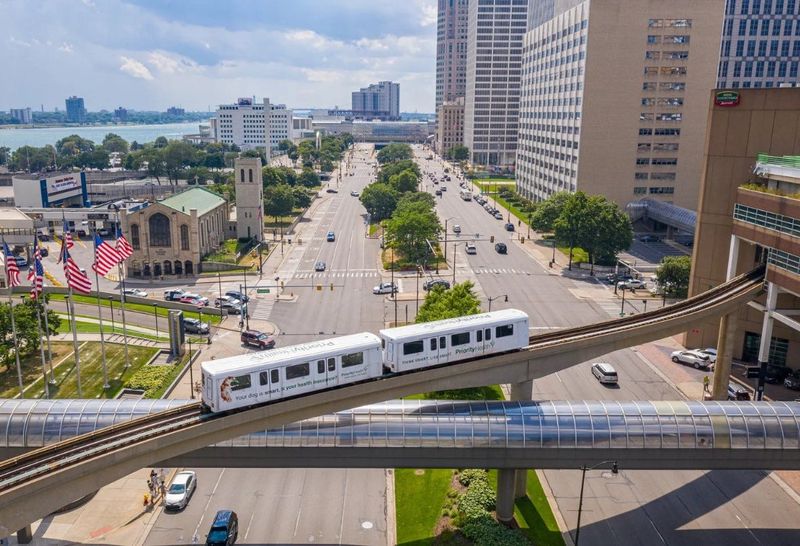 A Detroit People Mover vehicle crosses over Jefferson Avenue downtown.