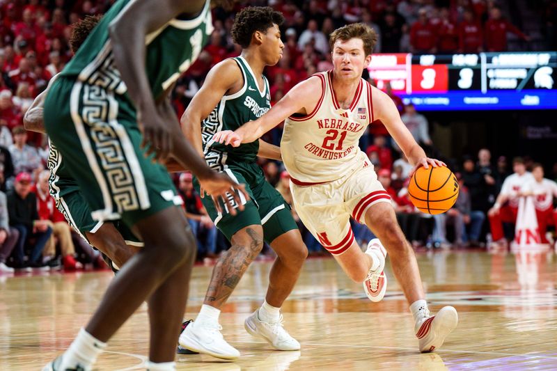 Nebraska Cornhuskers forward Pryce Sandfort (21) drives against Michigan State Spartans guard Jeremy Fears Jr. (1) during the first half at Pinnacle Bank Arena in Lincoln, Nebraska, on Friday, Jan. 2, 2026.