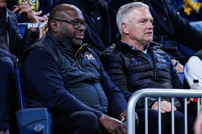 Michigan football running backs coach Tony Alford, left, and tight ends coach Freddie Whittingham, watch during the first half between Michigan and USC at Crisler Center in Ann Arbor on Friday, Jan. 2, 2026.