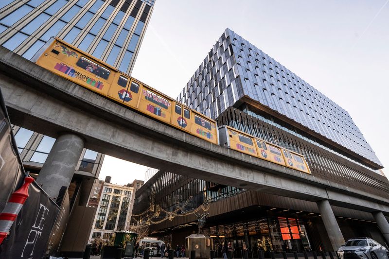 The Detroit People Mover moves past the two buildings of the Hudson’s Detroit development in downtown Detroit on Wednesday, Dec. 23, 2025.