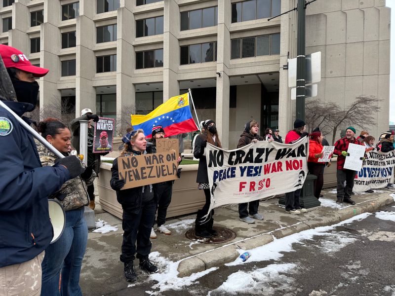 Demonstrators gather on Michigan Avenue in front of the Patrick V. McNamara federal building protesting the U.S. intervention in Venezuela on Sunday, Jan. 4, 2026.