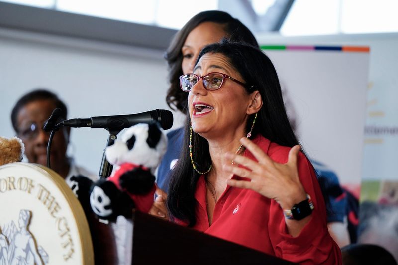 Detroit Mayor Sheffield, back, stands by as Dr. Mona Hanna speaks of the benefits to families who participate in RX Kids, a mom and baby support cash program for local families announced on Monday, Jan. 5, 2026 at the Franklin Wright Settlements in Detroit.