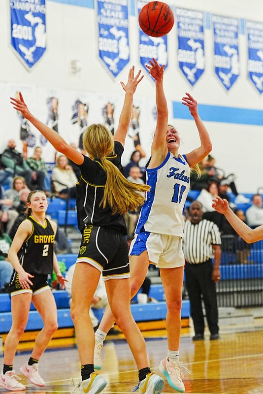 Rochester’s Taylor Parsons (10) shoots the ball over Groves; Miah Rickert (21) during the MHSAA girls basketball game at Rochester Hills high school in Rochester Hills, Mich., Tuesday, Jan. 6, 2026.