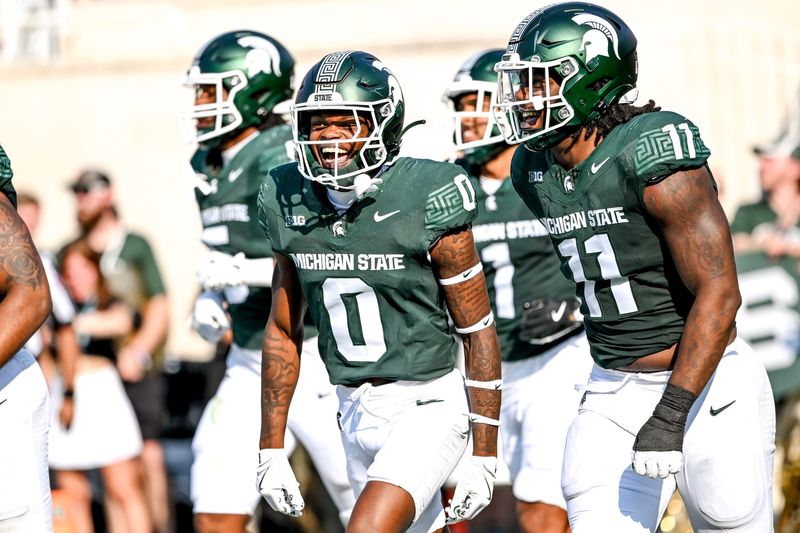 Michigan State's Charles Brantley, left, celebrates with Ken Talley after an interception against Prairie View A&M during the second quarter on Saturday, Sept. 14, 2024, at Spartan Stadium in East Lansing. Brantley's interception was called back on a penalty.
