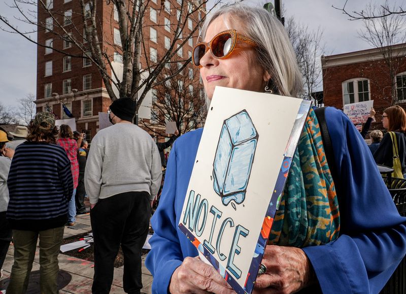 Lee Turner holds her homemade sign “No ICE” during a protest about along South Main Street near City Hall in downtown Greenville, S.C. Thursday, Jan 8, 2026. Renee Nicole Good, 37, was shot Wednesday in a residential neighborhood near downtown Minneapolis by an ICE agent, and captured on video by witnesses.