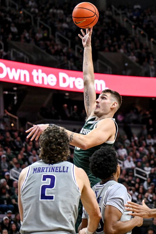 Michigan State's Carson Cooper scores against Northwestern during the first half on Thursday, Jan. 8, 2026, at the Breslin Center in East Lansing.