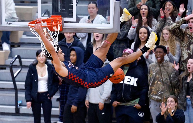 East Lansing's KT Thomas dunks against Holt, Friday, Jan. 9, 2026, at Holt High School.
