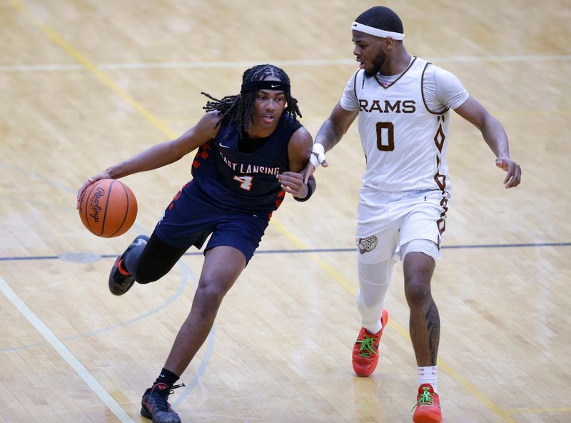 East Lansing's Tyree Anthony, left, drives against Holt's Kae'Vion Wilson, Friday, Jan. 9, 2026, at Holt High School.