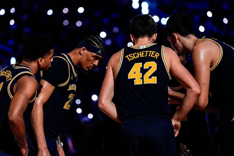 Michigan players huddle at a timeout against Wisconsin during the second half at Crisler Center in Ann Arbor on Saturday, Jan. 10, 2026.